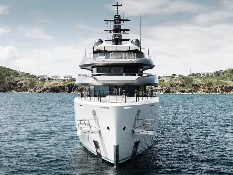 Bow-on off St Barths, Pangea shows the stacked tiers of her superstructure and the tender garages built into her flared topsides.