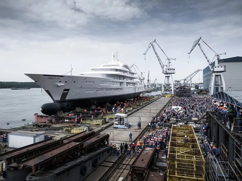 The hull, yard number Amels 477, leaves Damen Yachting's Galati shed in Romania in May 2023 before the tow north to Vlissingen for outfitting.
