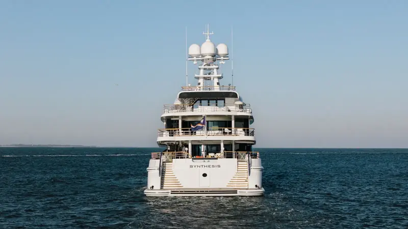 Synthesis stern-on during post-refit sea trials, her name across the transom and her original livery unchanged.