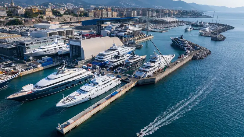 Amico & Co's Genoa waterfront, dry docks and covered sheds on one side of Waterfront Marina, moored superyachts on the other.