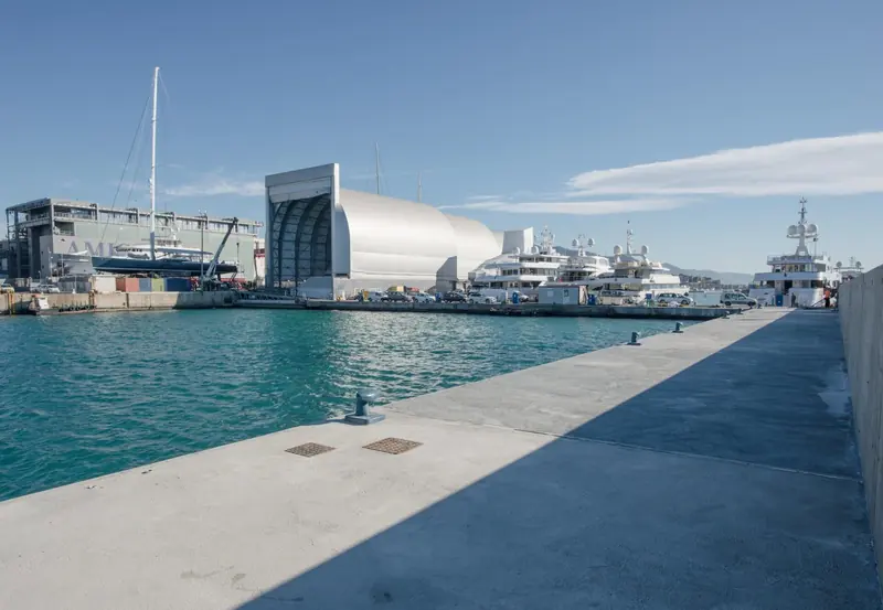 A sailing yacht sits hauled out beside the covered paint shed, one of 12 covered refit and repair bays on the 55,000 square metre site.