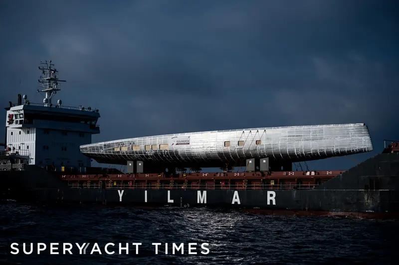 Argo 54's bare aluminium hull, Hull 459, arrives in Greece aboard the heavy-lift ship Yilmar in December 2022 - the yacht is still not delivered nearly four years later.