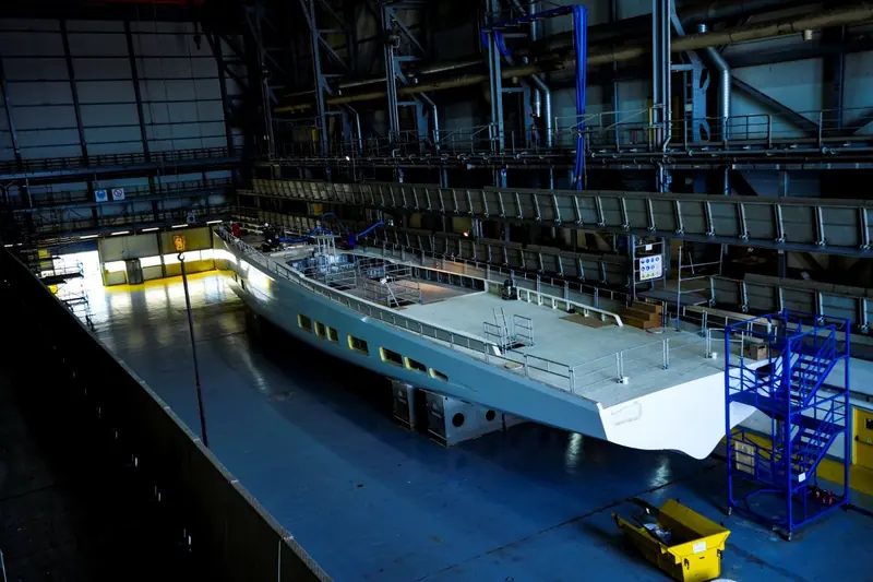 The hull inside Omikron's build shed at Lavrio. The yard has never published a revised delivery date since its original 2024 target.