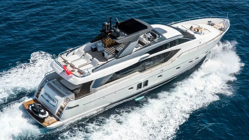 Astrimare II underway, her name and Valletta home port visible on the transom, a Sea-Doo tender launched from the garage.