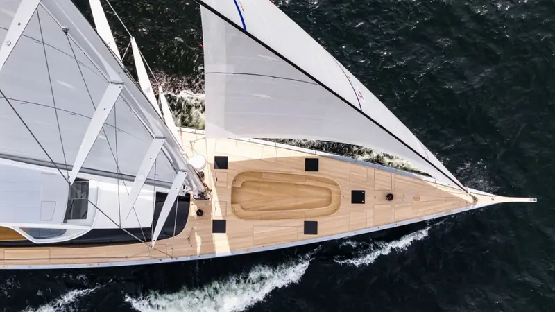 Under sail, Alice's teak foredeck and dual headsails are visible from above. Her telescopic keel extends from 4.15 to 6.4 metres on the same hull.