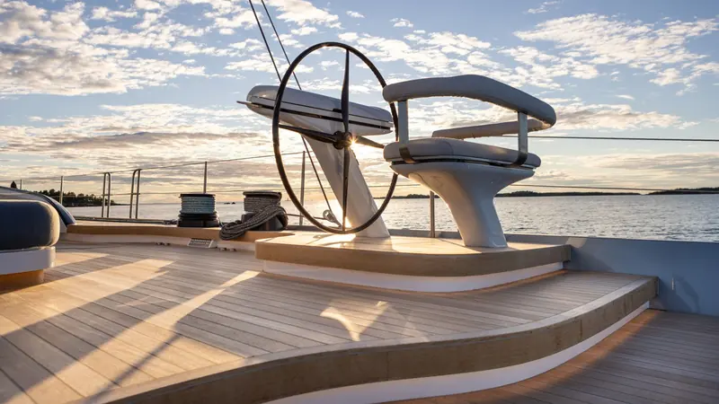 The twin wheels aft, where captive-halyard and in-boom-furling controls let a limited crew get underway within minutes.