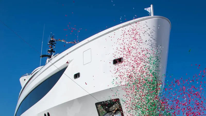 Confetti marks Dagger's naming ceremony at Benetti's Livorno yard in February 2026, the traditional send-off for a new hull before sea trials.
