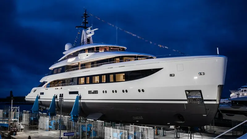 Dagger alongside at dusk, floodlit for her launch photographs, six decks visible including the Oasis Deck amidships.
