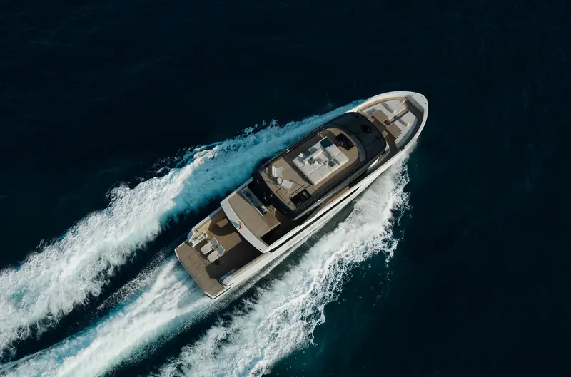 Seen from directly overhead, the BGX83 shows Bluegame's crossover layout: an open flybridge lounge forward of the helm and a full-beam aft cockpit for guests.