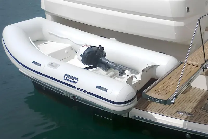 A Geniuss tender at a yacht's swim platform. The outboard sits on the sliding, tilting support that is the whole point of the system Callegari has just bought.