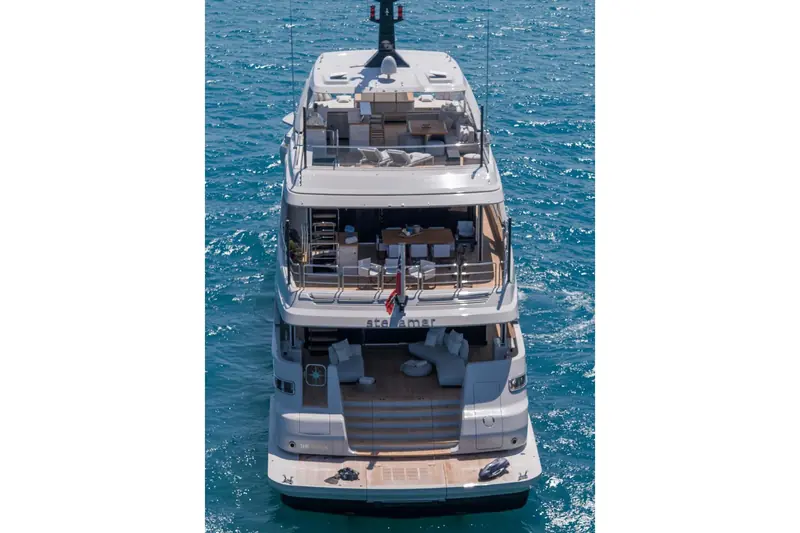 From above, the name Stellamar runs across the transom below a flybridge laid out for full alfresco dining.