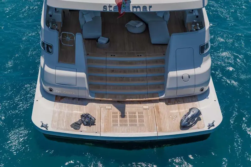 The lower-deck swim platform folds into a beach club, fins, a Seabob and a personal watercraft stowed either side of the tender garage hatch.