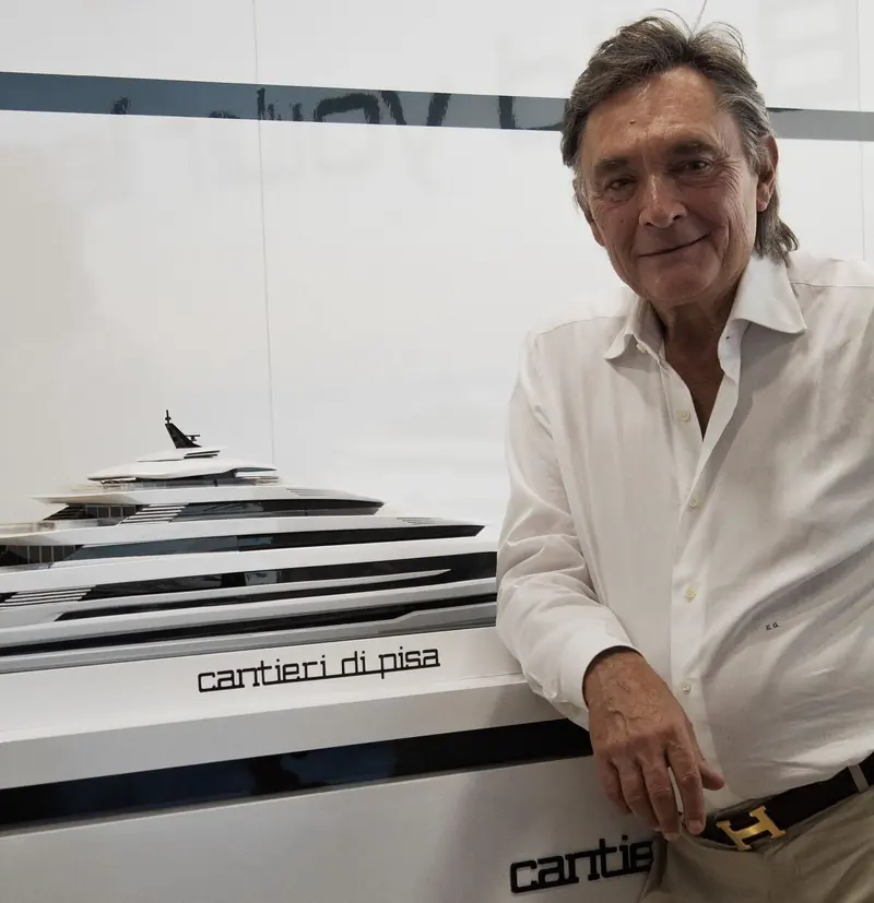Enrico Gennasio, who bought Cantieri di Pisa in 2021 and has now taken the title of Sole Director, beside a model of one of the yard's yachts.