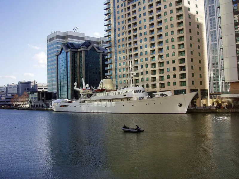 Christina O alongside at Canary Wharf, London, her tender in the water beside the 99.1 metre hull.