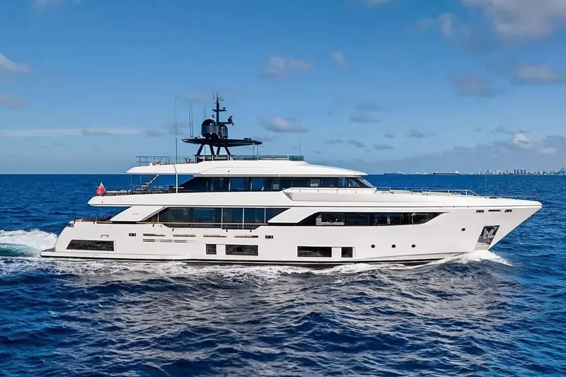 The 37.04m Custom Line Navetta 37 on a second pass, showing the full run of her superstructure glazing and the flybridge helm above it.