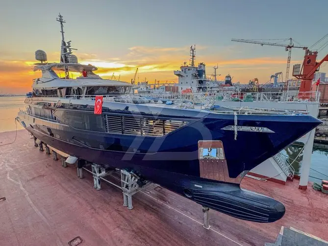 The same dry-dock scene from further back, with the cranes and basin of Dearsan's Tuzla shipyard - a yard whose main business, before Queen Yaz, was patrol boats and commercial vessels.