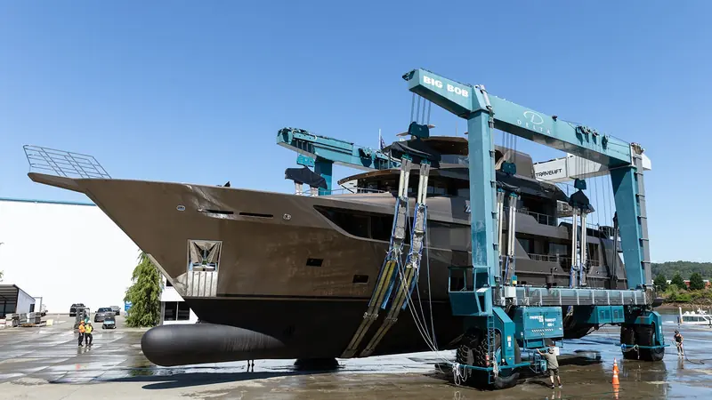 Delta Marine's travel lift Big Bob carries Zembra bow-first through the launch sequence at the Seattle yard.