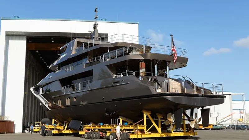 Zembra rolls out of Delta Marine's construction shed on a transport trailer, her twin propellers and rudders exposed before splashdown.