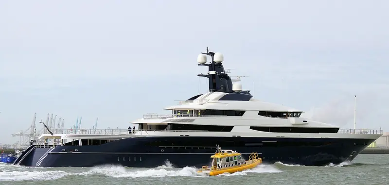 Equanimity passes a pilot boat on the Nieuwe Waterweg during 2014 sea trials, before her helideck and beach club were later stripped out