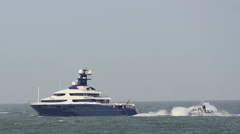 Equanimity under way with a police escort - the same hull Gabe Newell later bought, renamed Draak and rebuilt as a dive-support ship