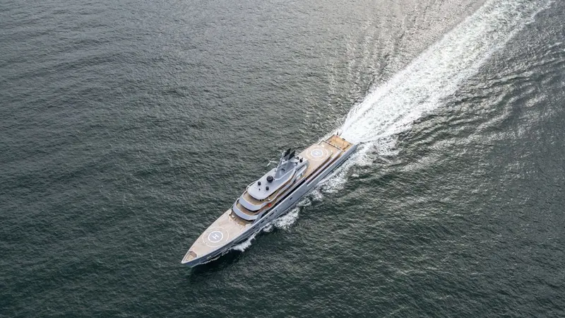 An aerial view at speed shows Dragonfly's full 142.1-metre length and 20-metre beam, the scale that later left her too big for the dedicated superyacht berths at Marina Port Mahon in Menorca.