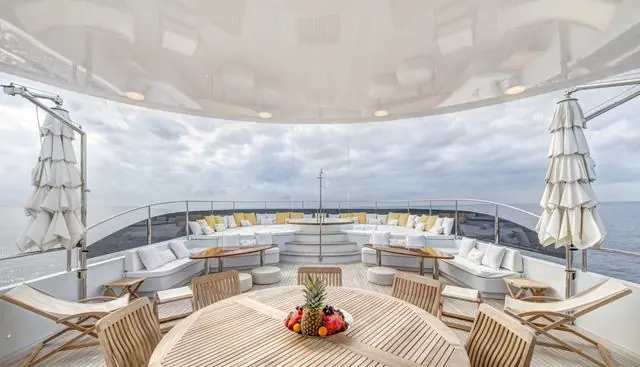 Aft sundeck dining under the awning, set up for al fresco meals between excursions.