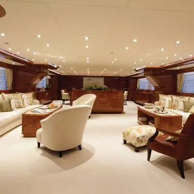 The main saloon, finished in dark mahogany joinery typical of her 2011 build year.