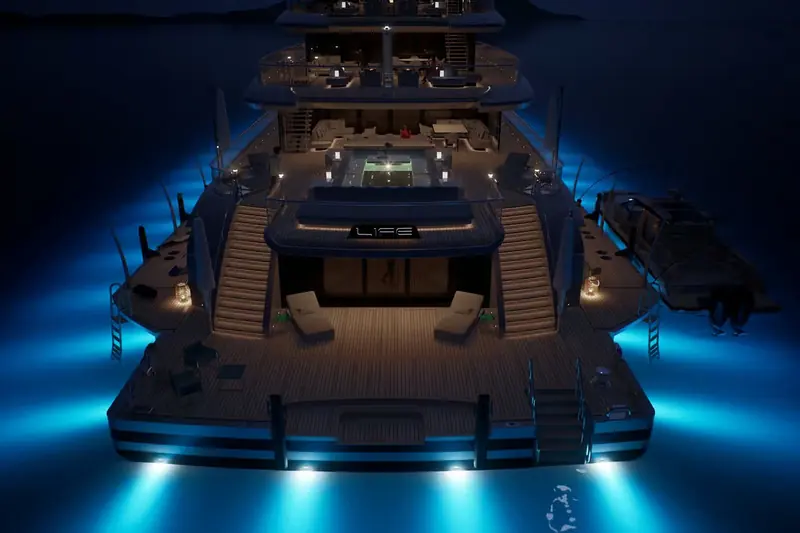 The stern swim platform lit at night, with tender access and underwater lighting off the transom.