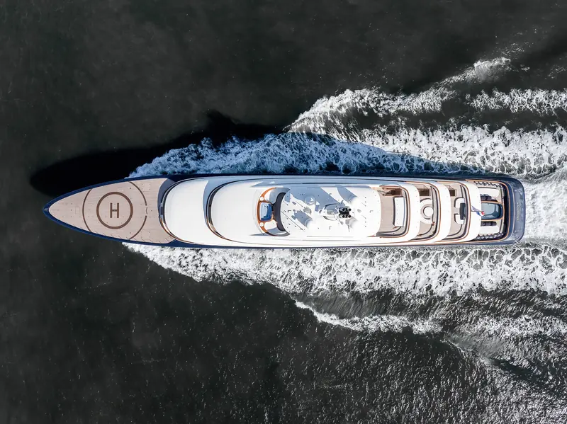 Seen directly from above, the full 101.2-metre deck plan runs from the forward helipad to the stern, where the hull's name is lettered.