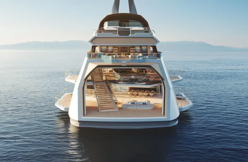 Hive at anchor, stern-on, showing the two-storey beach lounge and the stairs connecting the atrium's balconies.