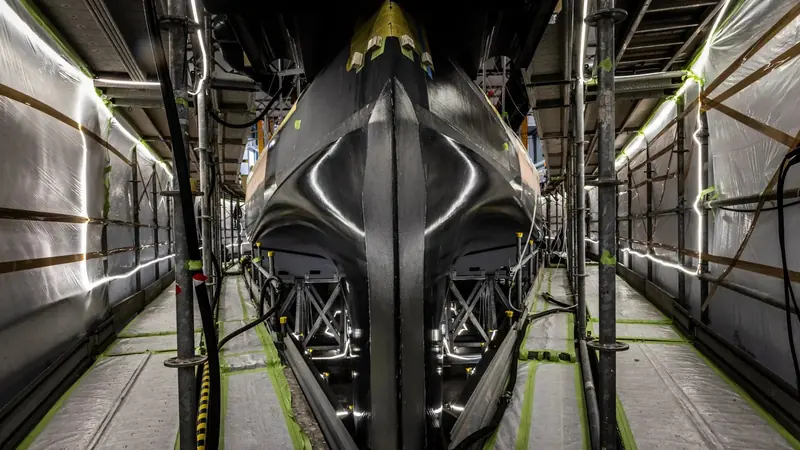 A structural component of the build under a gantry crane in Pisa, photographed for reporting on Hypersail's energy and propulsion systems.