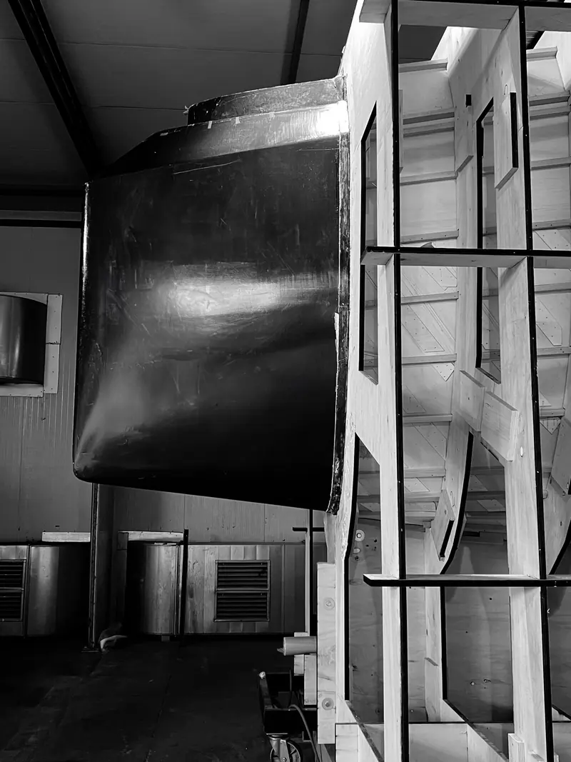 A hull under construction inside Maxi Dolphin's Erbusco shed, the fiberglass and mould work at the heart of the yard the fire tore through.