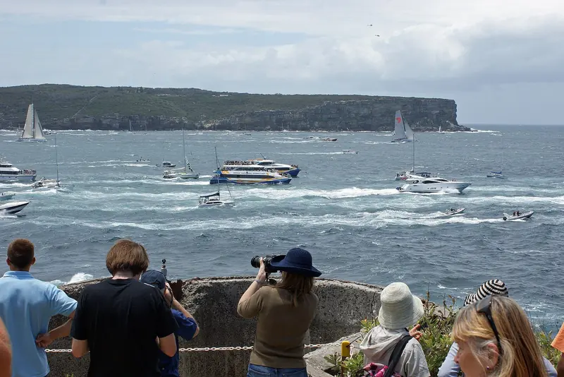 Leading and trailing yachts pass North Head under spectator escort at the start of the Sydney to Hobart, the race Wild Oats XI won on line honours nine times before her rebuild as Palm Beach XI.