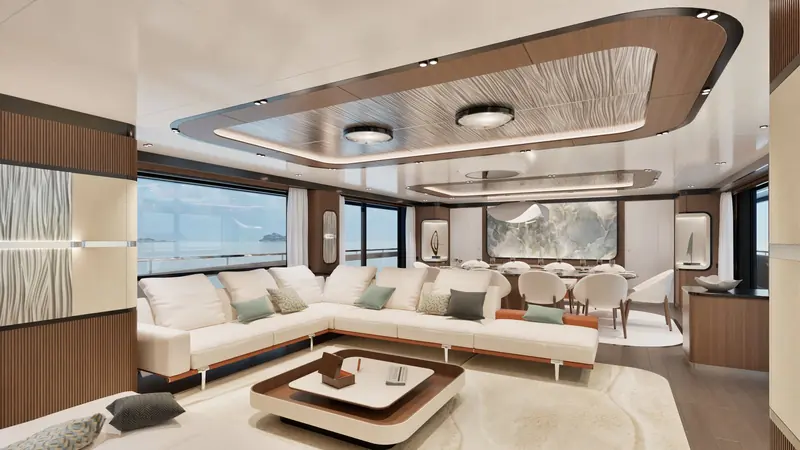 The GX42's main-deck saloon and dining table, finished in walnut panelling with a stone feature wall.
