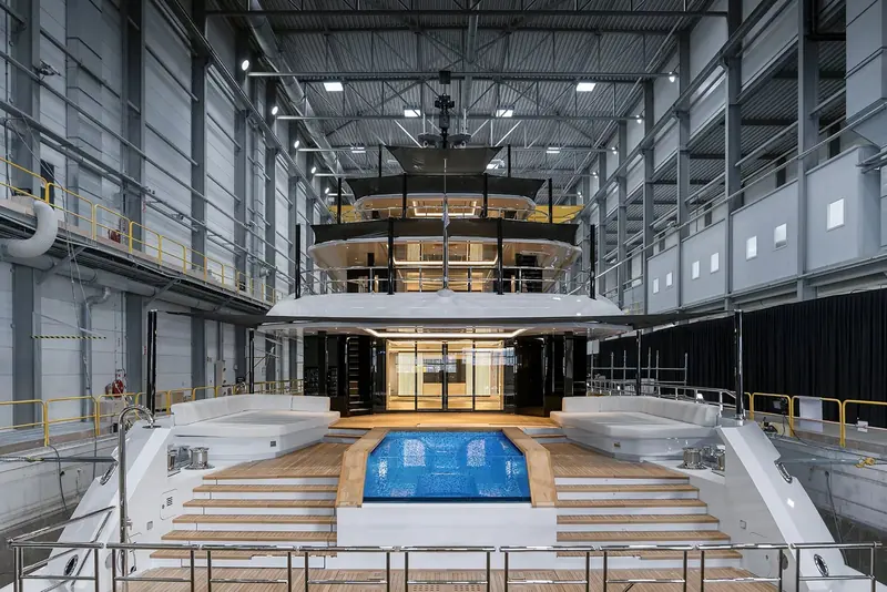 The aft decks looking forward, with the pool still under its protective cover. Heesen puts her at 920 GT, which is modest for 57 metres, and this is where the volume went: open deck rather than interior.