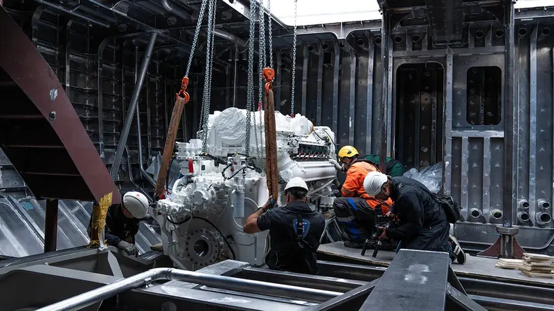 Machinery lowered into the open hull before the superstructure closed it in. She carries two MTU 16V2000M72 diesels of 1,440 kW each, for 18 knots flat out and 12 knots cruising.