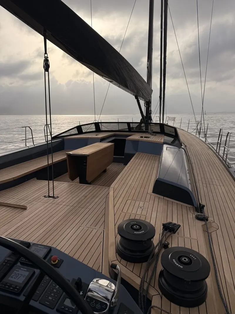 The aft cockpit and teak deck, seen from the helm station; a folding bathing platform and a 3.5-metre tender garage sit further aft.