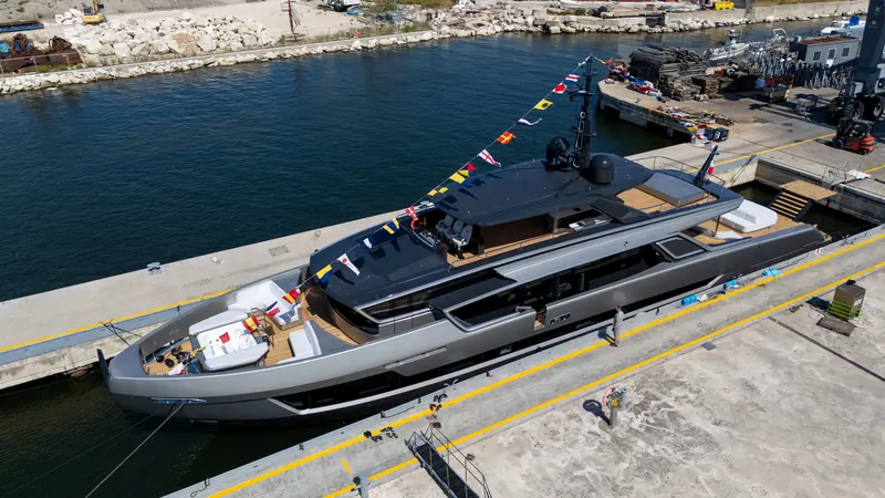 Fast Naan alongside after launch, her carbon-hardtop sundeck and the single port-side walkway to the bow both visible from this angle.
