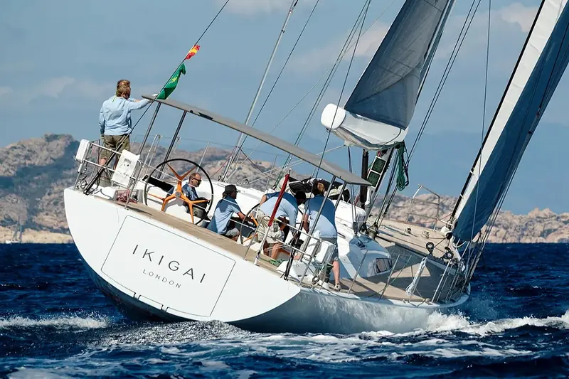 Six crew work Ikigai's twin wheels and mainsheet through a mark rounding, the low freeboard and wide cockpit typical of the Judel/Vrolijk performance-cruiser hull built by JFA in 2001.