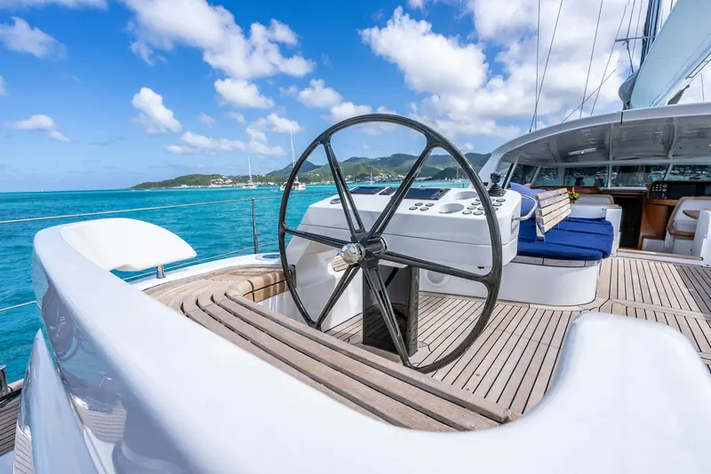 The aft wheel and steering station, with flush deck hardware and a dedicated tender garage keeping the working deck clear.