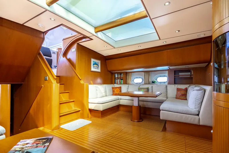 The lower saloon, finished in restrained teak with a skylight overhead - Jongert's craftsmanship without the heavier inlay work of earlier models in the range.