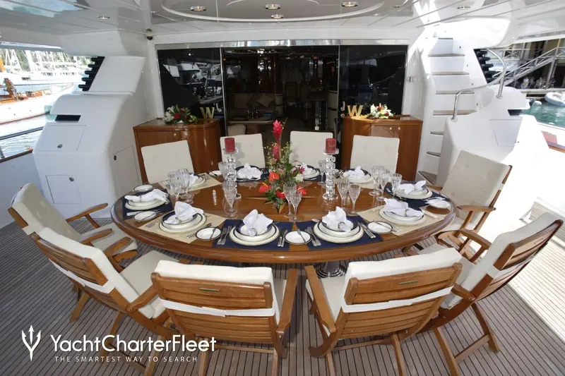 Formal dining laid on Laurie I's aft deck. She sleeps 10 guests across 5 cabins with a crew of 6.