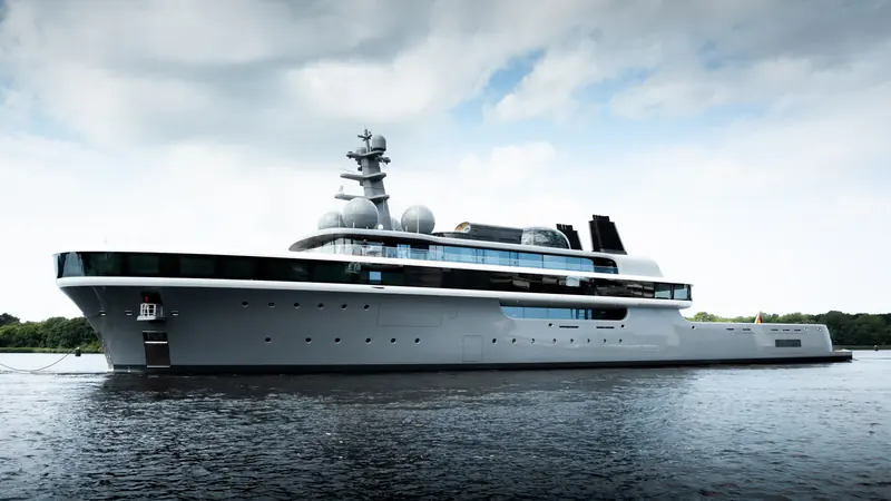 Nausicaa underway near Lurssen's Rendsburg yard. The explorer-style profile is Marc Newson's, a deliberate departure from Lurssen's usual tri-deck styling.