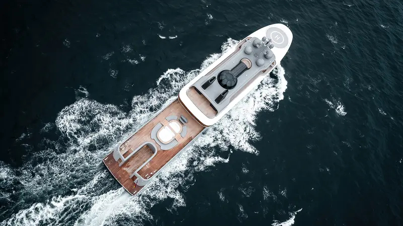 Seen from above: the helipad forward, the twin black funnels amidships, and the radar mast carrying the yacht's sensors and satellite domes.