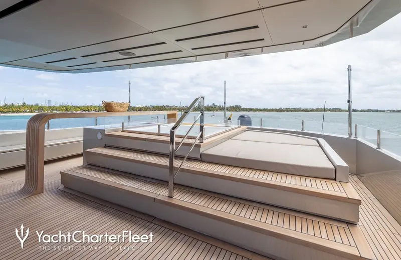 The forward deck jacuzzi and sunpad, with Miami's shoreline behind. Twin MTU 12V 2000 M94 diesels give her a 4,950-nautical-mile range at 10 knots.