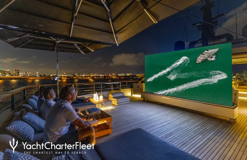Guests at the outdoor cinema, screening aerial footage of Maverick herself at anchor - one of the amenities a new owner inherits along with her working charter book.