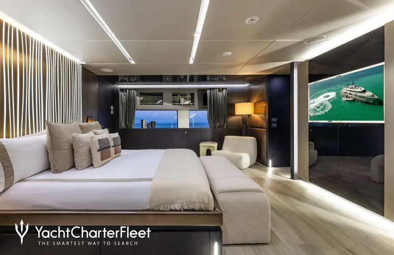 The full-beam master suite, with wraparound windows and a screen showing Maverick from above - the layout that Burgess and Kitson Yachts say rivals yachts over 50 metres.