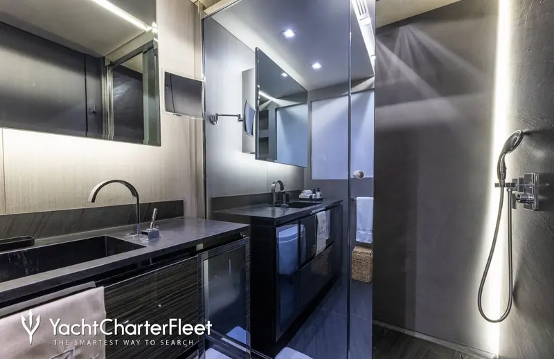 A guest bathroom finished in dark stone and mirror, one of the interior details behind the 2013 hull's asking price of EUR 10,899,000 before its final, undisclosed sale.