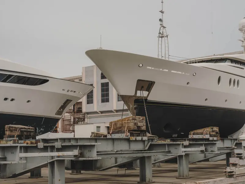 A superyacht sits blocked up on a floating dry dock at MB92 Barcelona, the kind of refit project the yard's new 680-tonne Travelift is built to move faster.