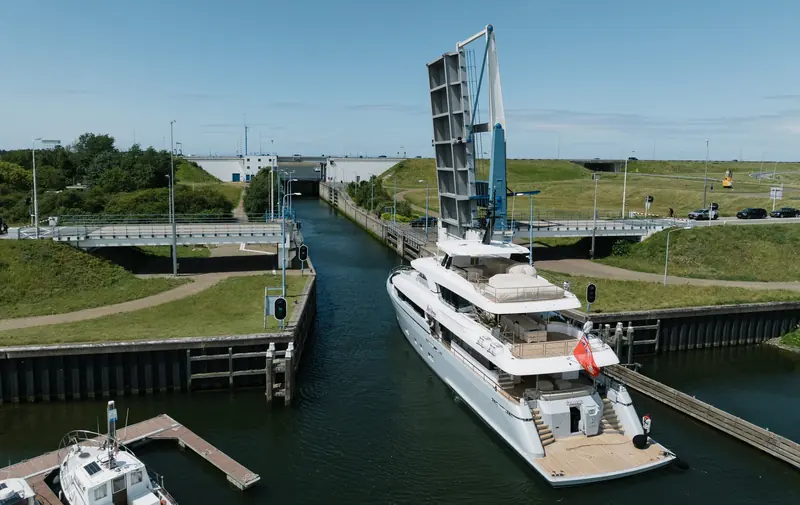 Lollipop underway, her sundeck visible above the wheelhouse - the deck where her owners specified a custom Jacuzzi behind curved, candy-inspired glass.